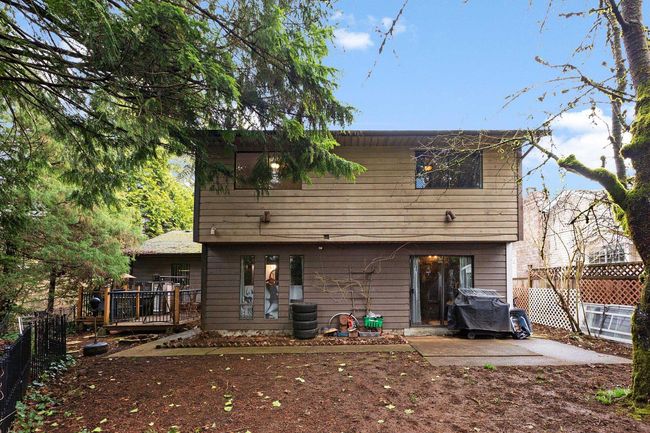 Back of house featuring a wooden deck and a patio area | Image 27