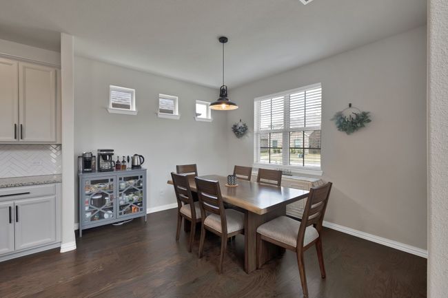 Dining room with dark wood-type flooring and baseboards | Image 12
