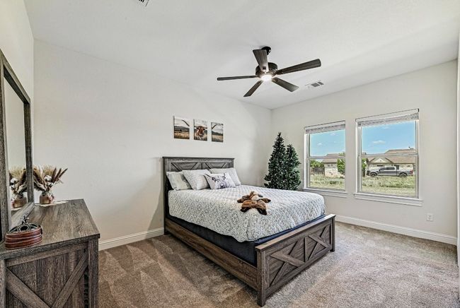 Carpeted bedroom with baseboards and a ceiling fan | Image 22