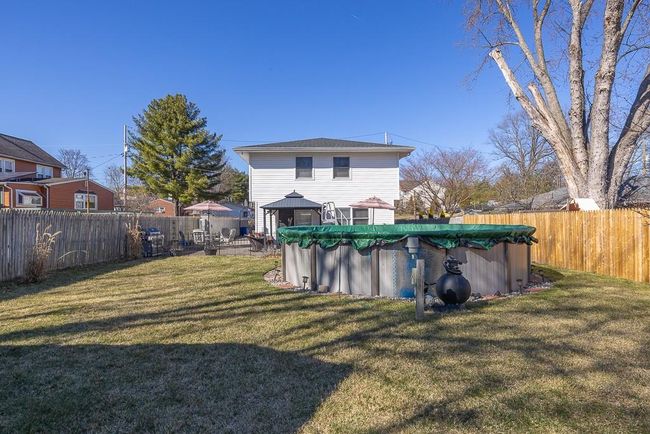 Rear view of property with a fenced backyard and pool | Image 22