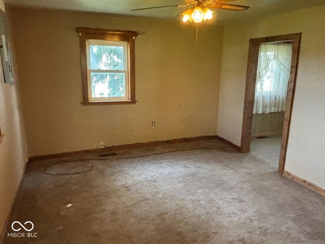 empty room with carpet flooring, baseboards, and ceiling fan | Image 16