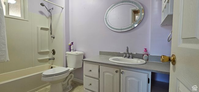 Full bathroom featuring tile patterned flooring, vanity, bathtub / shower combination, and toilet | Image 26