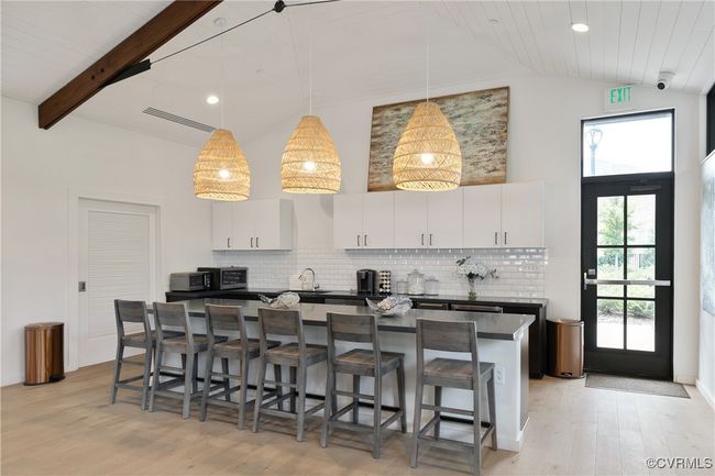 Kitchen featuring dark countertops, white cabinetry, hanging light fixtures, and visible vents | Image 49
