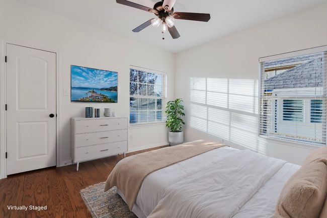 Bedroom featuring vaulted ceiling, wood finished floors, baseboards, and ceiling fan | Image 15