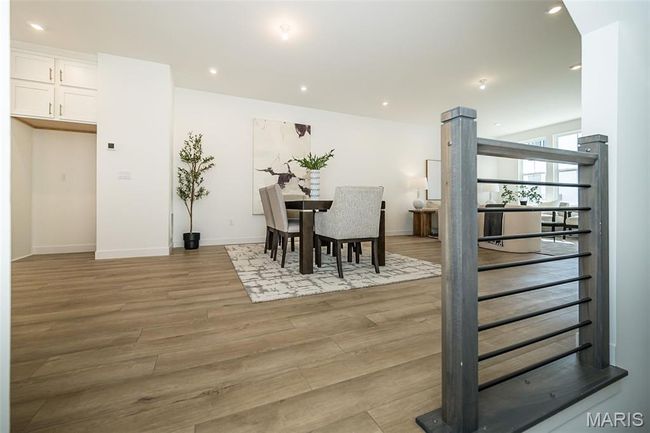 Dining room featuring light wood-style flooring, recessed lighting, and stairway | Image 30