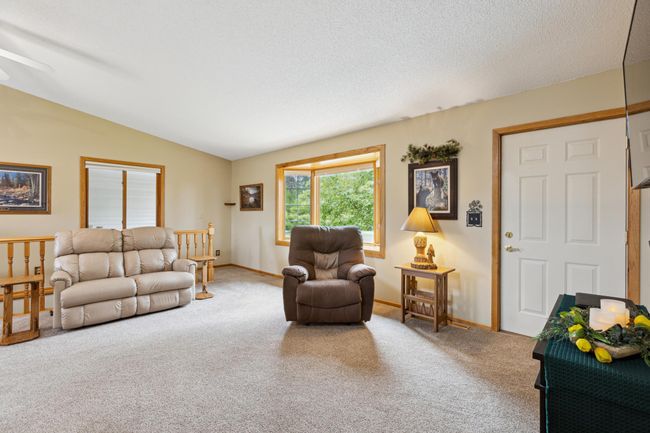 Enter through the front door into a spacious living room. | Image 12