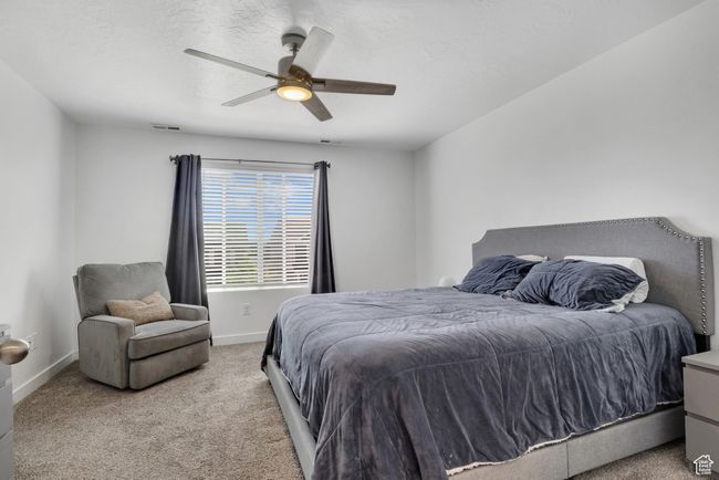 Bedroom featuring carpet flooring, baseboards, and a ceiling fan | Image 13
