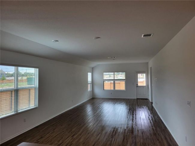 Unfurnished room featuring dark wood-type flooring and lofted ceiling | Image 12