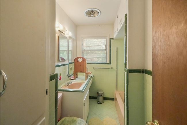 Full bathroom featuring Retro mint & green peach walls & flooring. Vintage Peach porcelain Tub, toilet & sink | Image 4