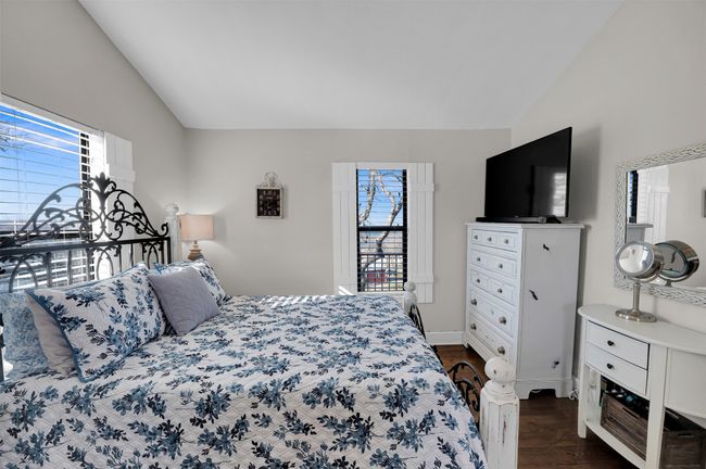Bedroom with vaulted ceiling and dark wood finished floors | Image 10