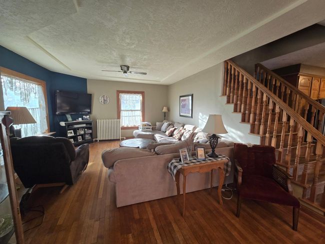 Open to living room accented with the open stairway | Image 12