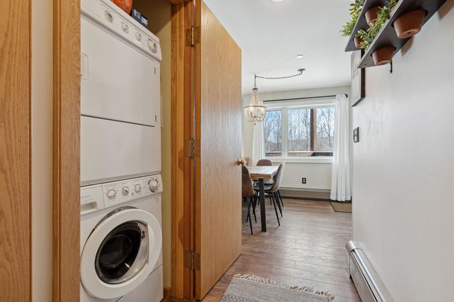 Washer/dryer located in hallway, along with other storage. | Image 12