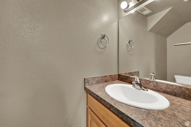Half bathroom with vanity and a textured wall | Image 22
