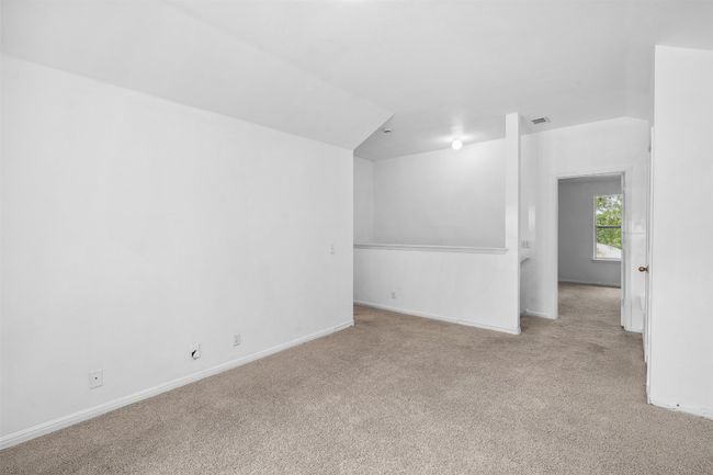 Carpeted empty room with visible vents and baseboards | Image 27