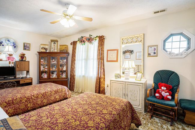 Bedroom with multiple windows and a ceiling fan | Image 21