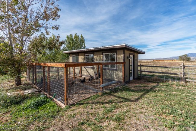 View of outbuilding featuring a lawn and a rural view | Image 49