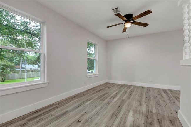 Upstairs game room with large window and ceiling fan. | Image 27