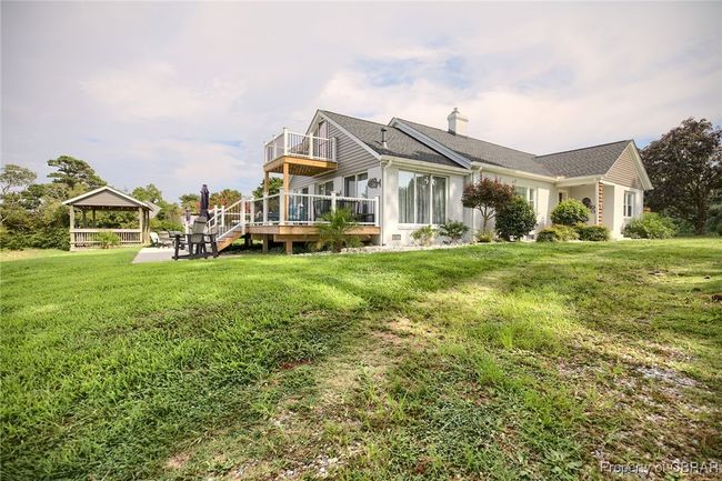 Rear view of property featuring a gazebo, a yard, and a wooden deck | Image 24