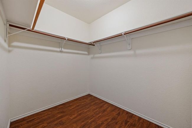 Walk-in closet with ample storage space. | Image 19