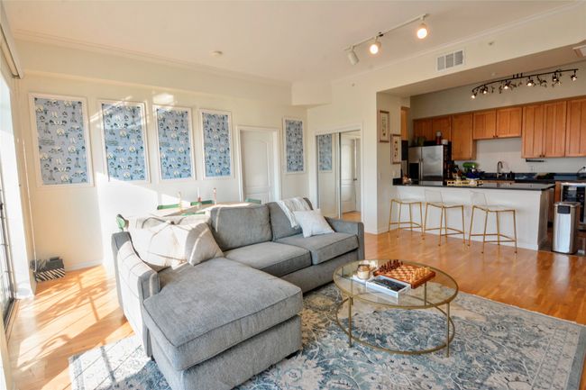 Living area with light wood finished floors, ornamental molding, and rail lighting | Image 29