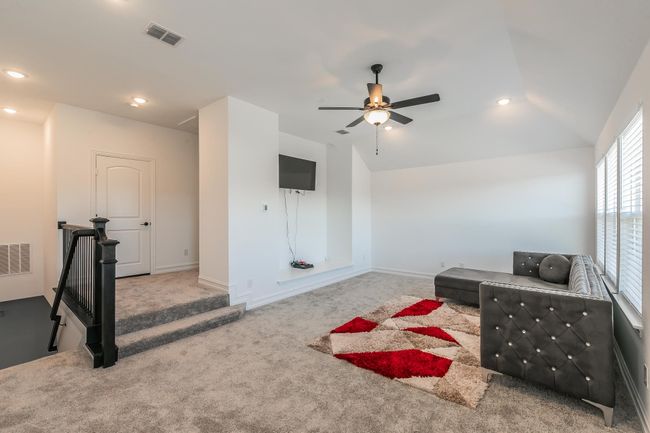 Living area with ceiling fan, carpet floors, and lofted ceiling | Image 31