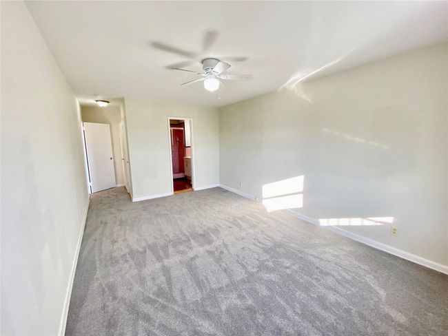 Unfurnished room featuring a ceiling fan and carpet floors | Image 8