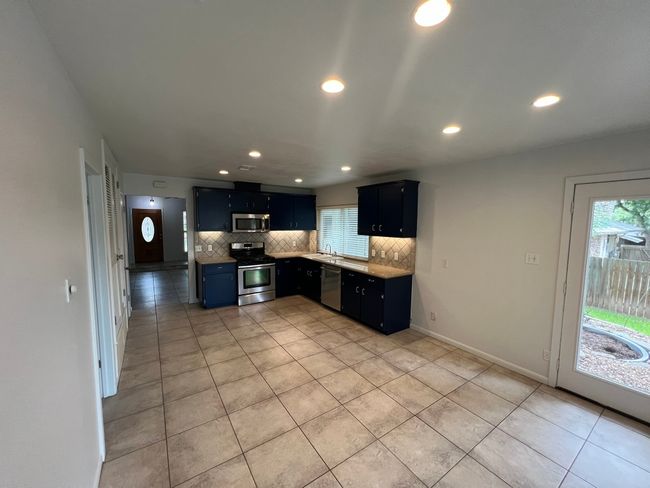 Kitchen with stainless steel appliances, backsplash, dark cabinets, healthy amount of natural light, and recessed lighting | Image 6