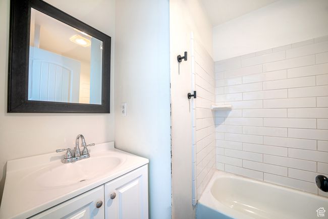 Bathroom featuring bathing tub / shower combination and vanity | Image 15