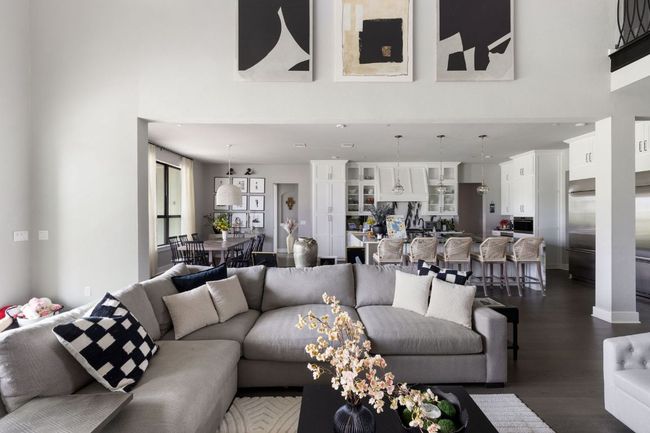 Living room featuring a towering ceiling and dark wood-style floors | Image 4