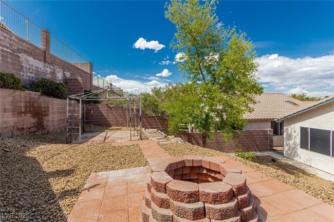 View of yard featuring a gazebo, a fenced backyard and an outdoor fire pit | Image 33
