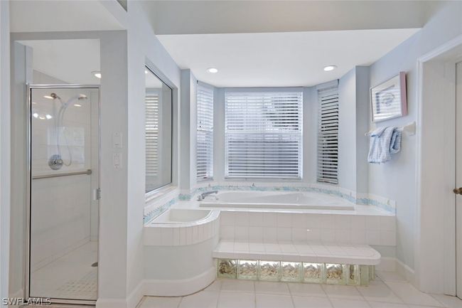 Bathroom with plus walk in shower, tile patterned flooring, and a healthy amount of sunlight | Image 26
