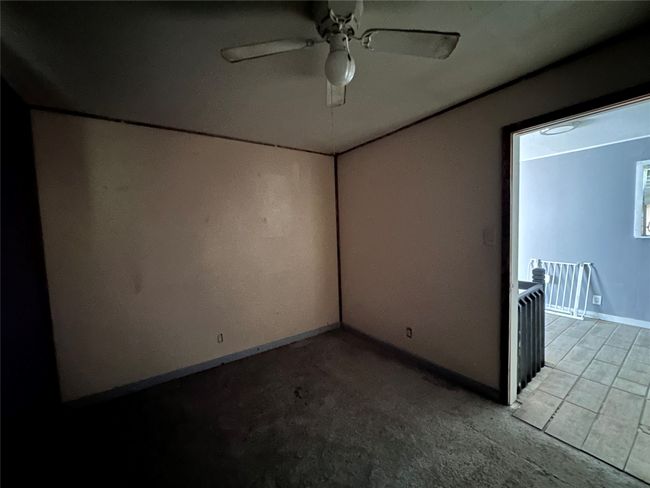 Spare room featuring a ceiling fan, baseboards, and carpet flooring | Image 15