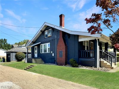 View of side of property with a lawn, cooling unit, and covered porch | Image 2