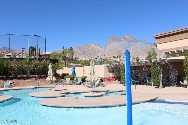 Community pool featuring fence, a mountain view, and a patio | Image 29