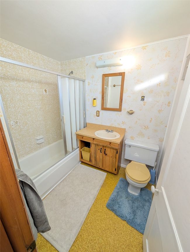 Full bathroom with vanity, combined bath / shower with glass door, and toilet | Image 16