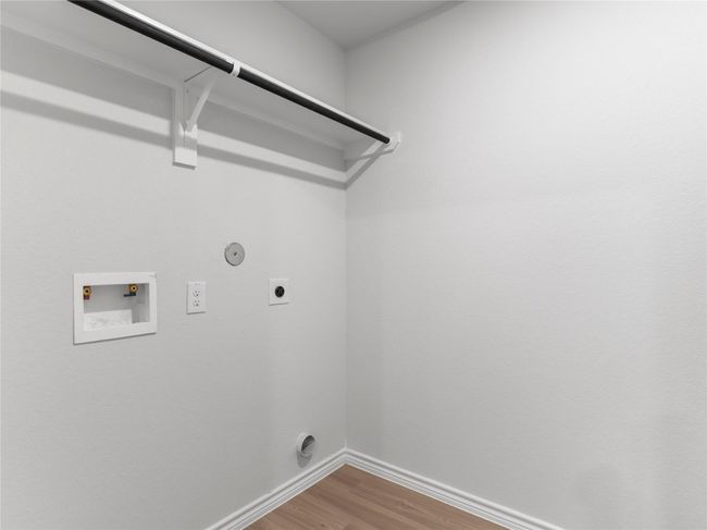 Convenient utility room with washer/dryer hookups and built-in shelving for effortless organization. | Image 8