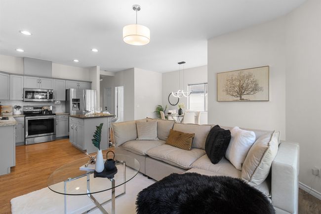 Living room with light wood-style floors, recessed lighting, and a chandelier | Image 12