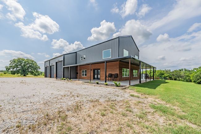 Back of property with a patio area, a yard, and a detached garage | Image 5