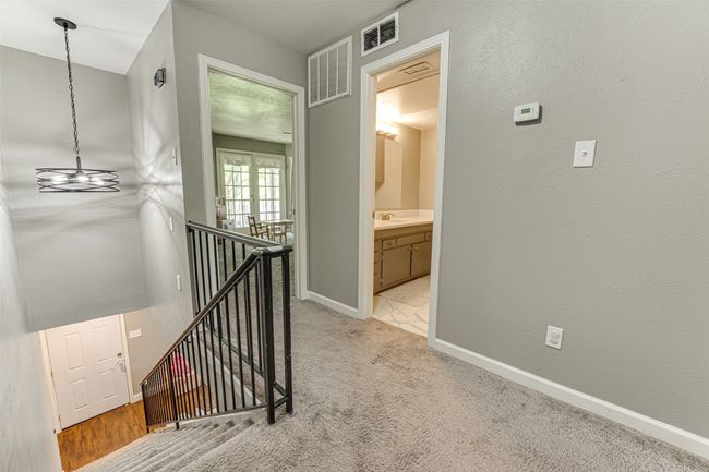 Hall featuring visible vents, baseboards, an upstairs landing, and light colored carpet | Image 20
