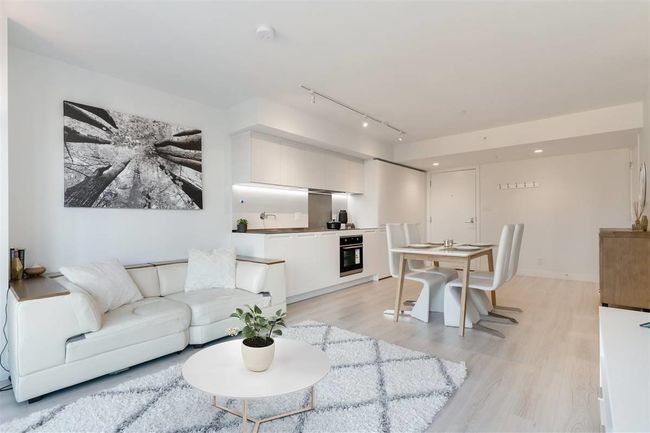 Living room featuring track lighting, light wood finished floors, and baseboards | Image 5