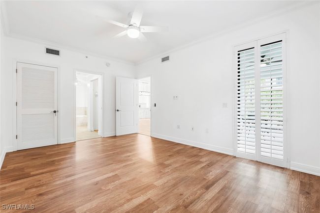 Spare room with ornamental molding, light hardwood / wood-style flooring, and ceiling fan | Image 39