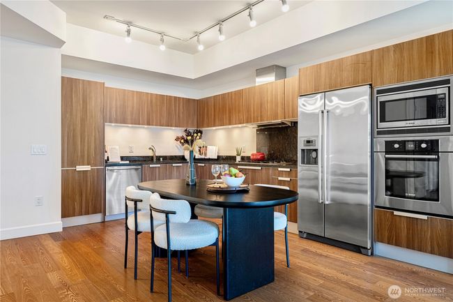 Sleek, modern kitchen with premium finishes, seamlessly integrated into the open layout. | Image 7