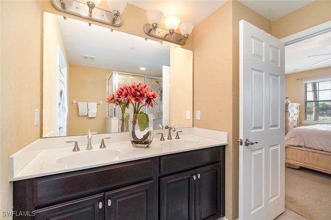 Ensuite bathroom with double vanity and a shower with shower door | Image 9