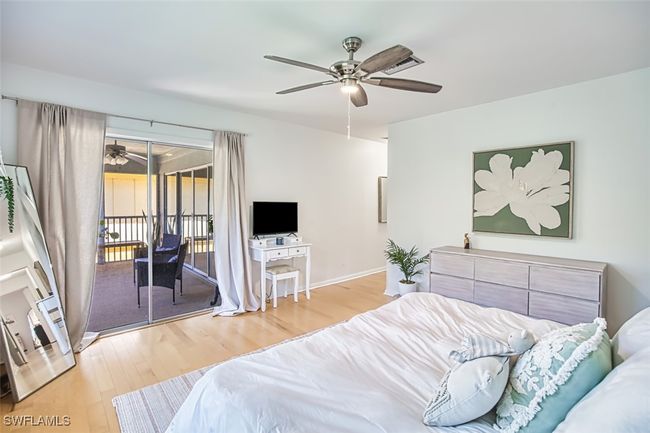 Bedroom with wood finished floors, access to outside, and ceiling fan | Image 20
