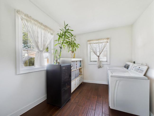 Washroom featuring separate washer and dryer and dark wood-style flooring | Image 24