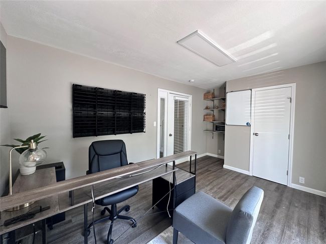Office space with wood finished floors and baseboards | Image 24