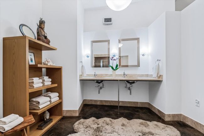 Bathroom featuring stained concrete floors, natural stone vanity and baseboards | Image 32