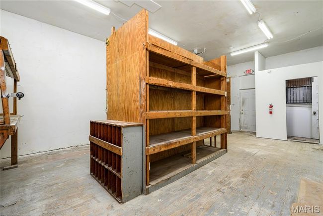 Back room has a bathroom, storage shelves that can be removed, back door to gated parking. | Image 7