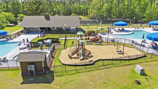 View of home's community with a swimming pool and an outdoor structure | Image 28