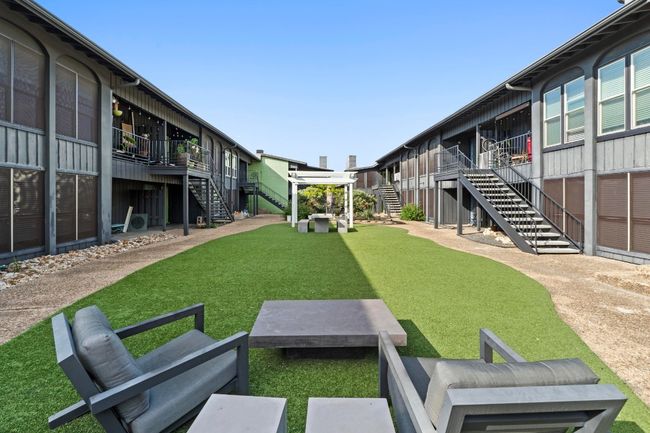 View of community featuring stairway, a lawn, and a deck | Image 28
